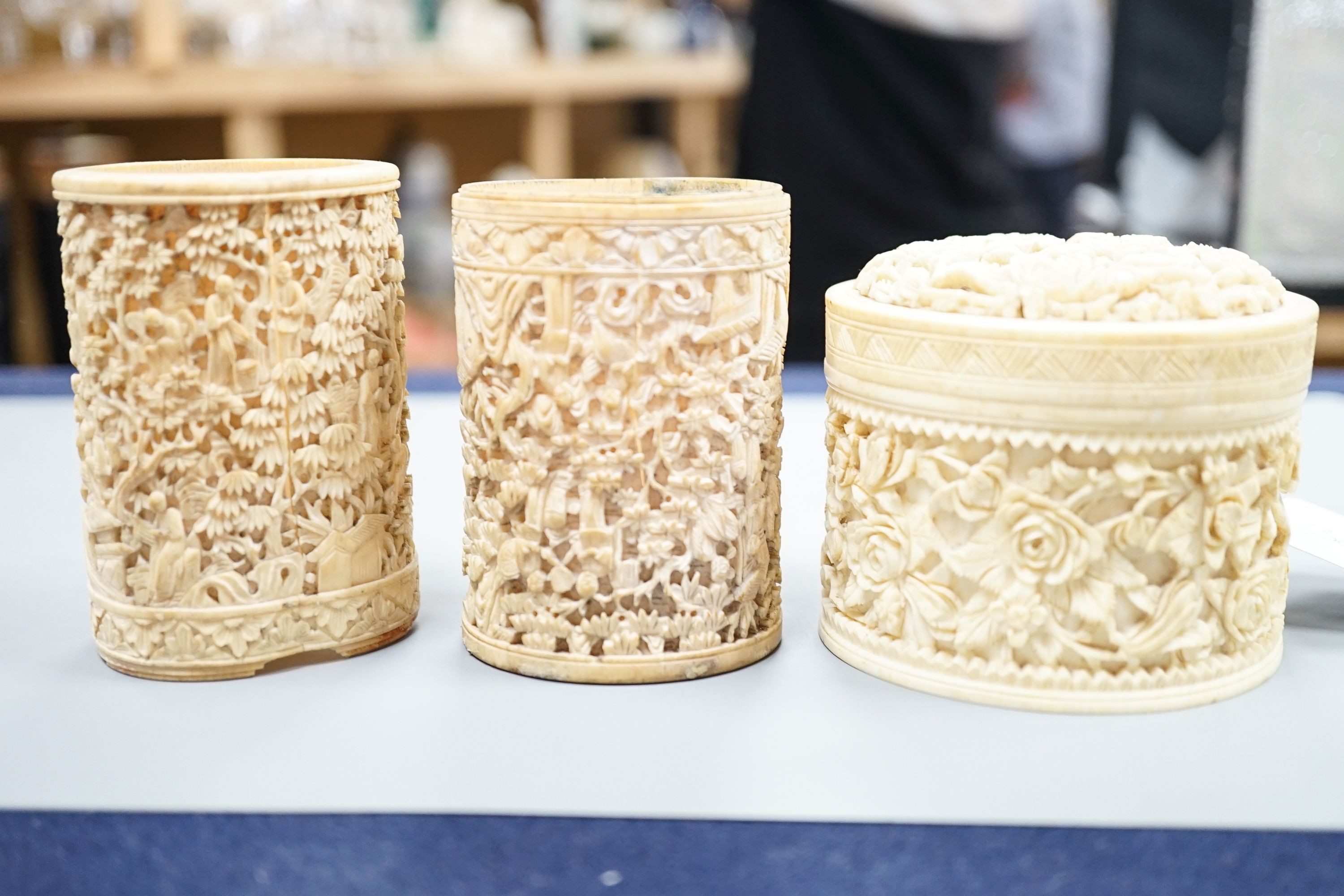 A pair of Chinese carved ivory pots and a Chinese ivory circular box and cover, 19th century